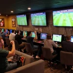 Tỷ lệ bóng đá kèo nhà cái showcased in an exciting sports betting lounge filled with fans placing bets on live matches.
